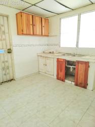 Basic kitchen with double windows, wood cabinets, tiled backsplash in Vacamonte Altos de las Huacas Panama