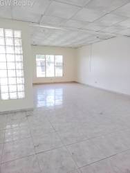 Living room large windows glass block wall tiled floor Panama Oeste Vacamonte house for sale
