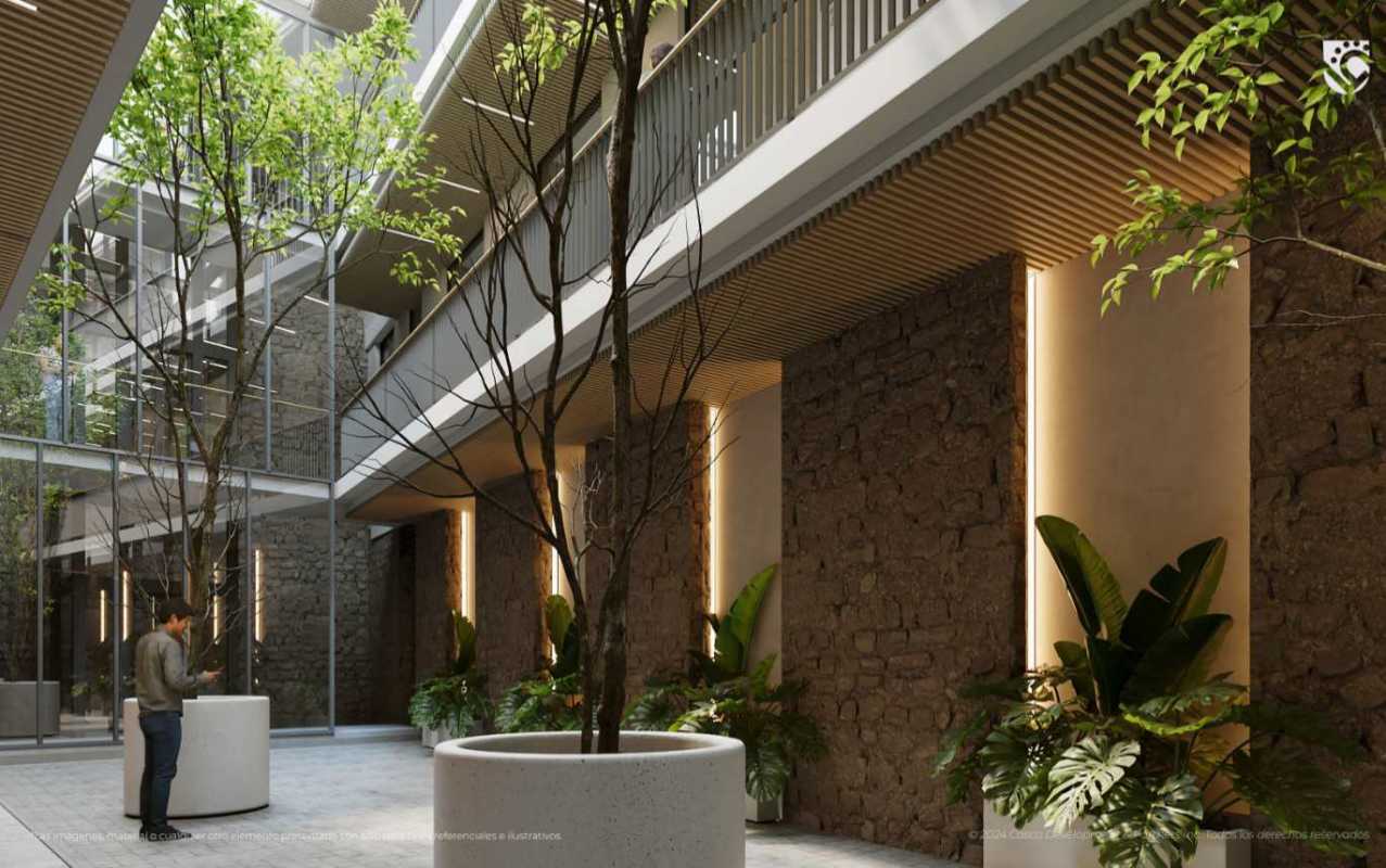 Green courtyard with stone walls, potted plants, natural light in colonial PH Casco Viejo