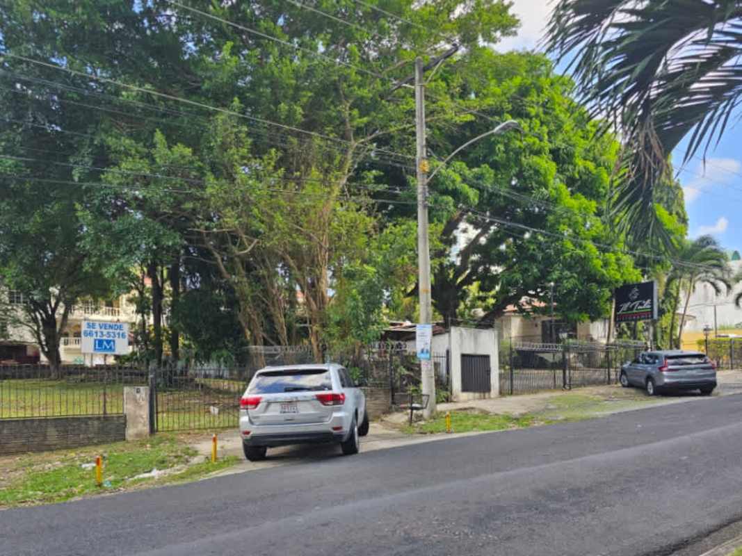 Vacant fenced property with mature trees and signage beside Multiplaza in prime Panama City location