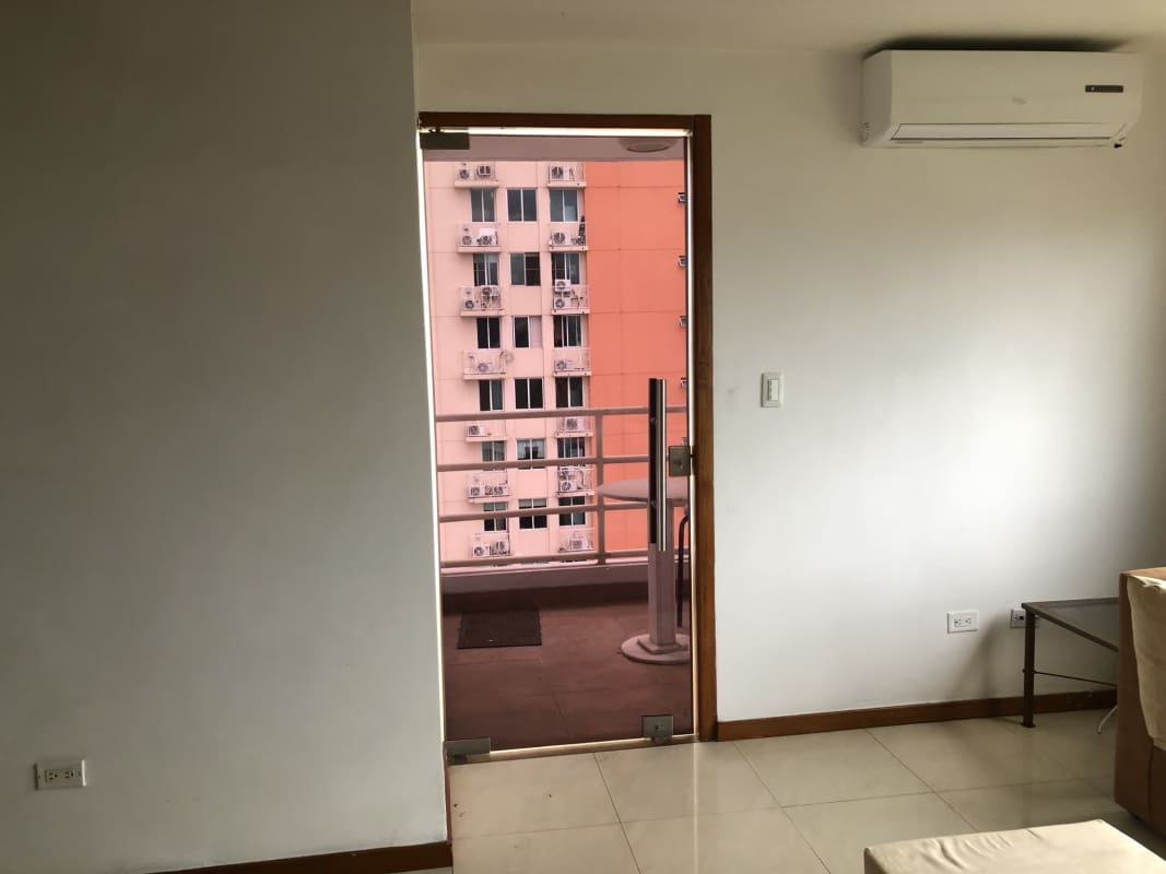 Balcony with round table and chairs overlooking city skyline in PH Torres de San Francisco Panama
