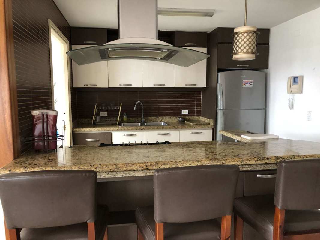 Kitchen with granite counters, breakfast bar, stainless appliances, pendant lights in PH Torres de San Francisco apartment