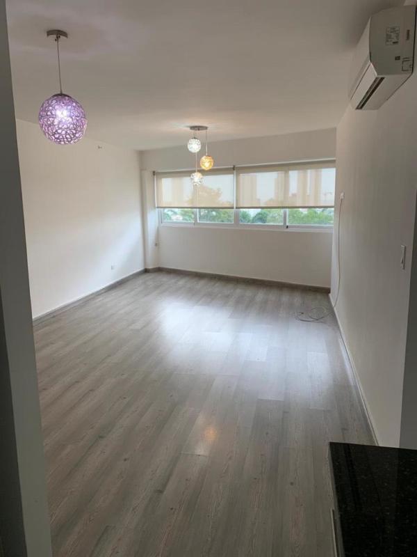 Large multi-use office space with modern lighting, exposed ceiling, and tile floors in San Francisco Panama