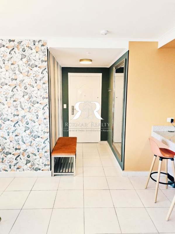 Remodeled kitchen with granite counters, vibrant barstools, mosaic backsplash, stainless appliances Panama