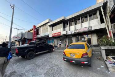 Two level commercial building with signage parking and stairs in Edificio Ricord Barrio Colón Panama