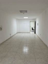 Open interior of commercial rental space with tile floor white walls and ceiling lights Ricord Building Panama