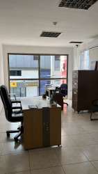 Unfurnished office space with multiple barred windows and tiled floors at Edificio Ricord Barrio Colón Panama