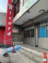 Commercial building facade with accessibility ramp and metal shutters for offices in Edificio Ricord Barrio Colón Panama