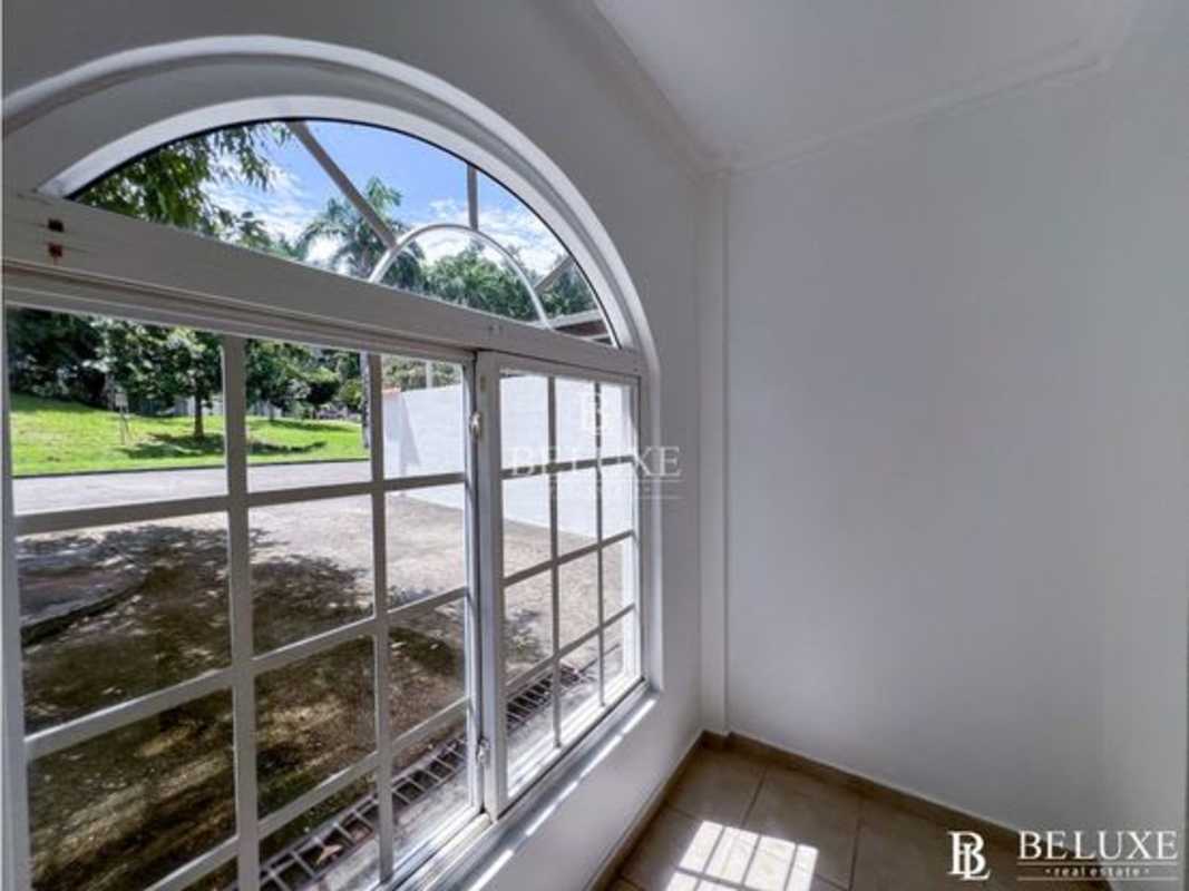 Interior niche sunroom with large arch window natural light in Clayton house for rent