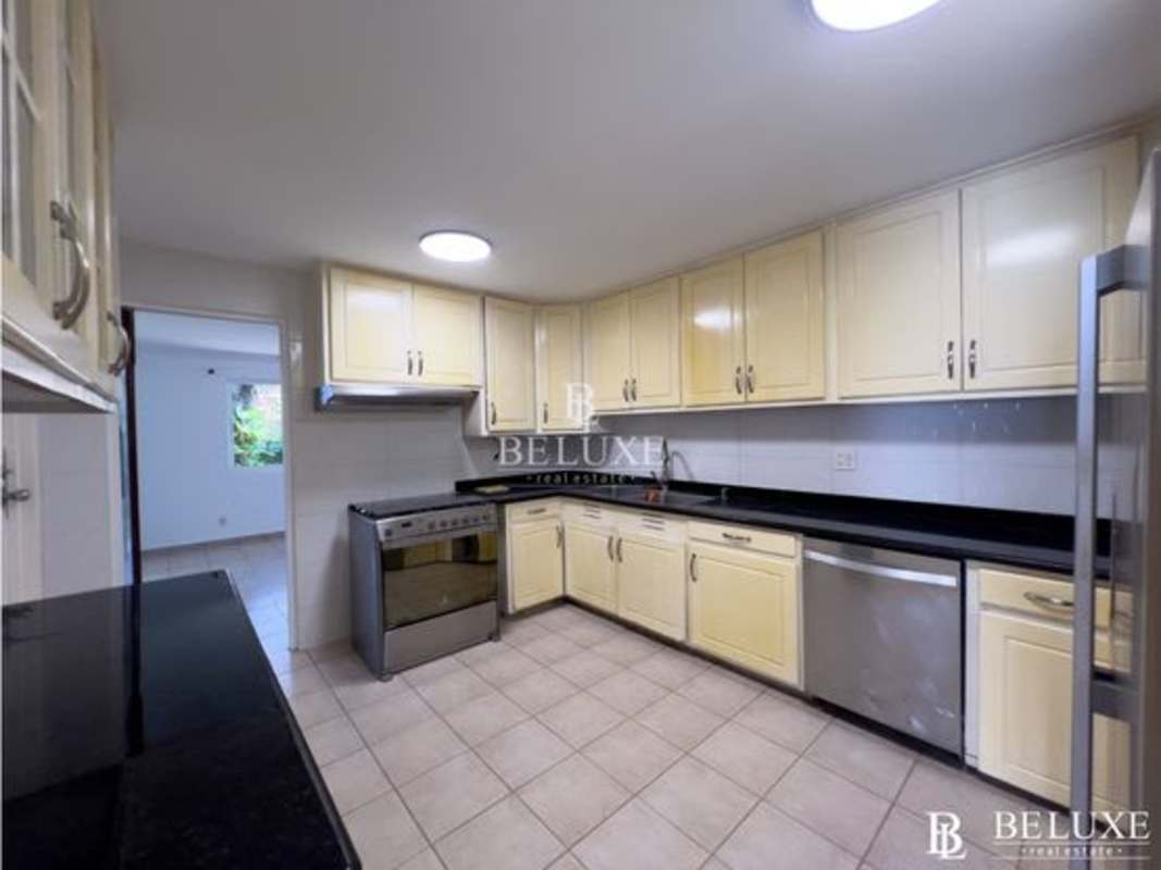 Kitchen with cream cabinets granite countertops stainless appliances for rent Clayton Panama