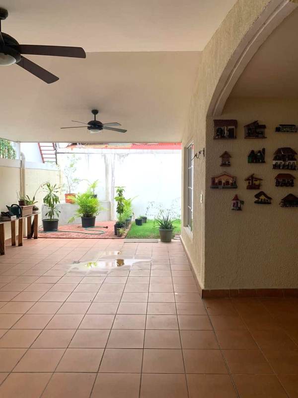 Spacious bedroom with tufted bed and neutral decor in Dorado Springs Panama City