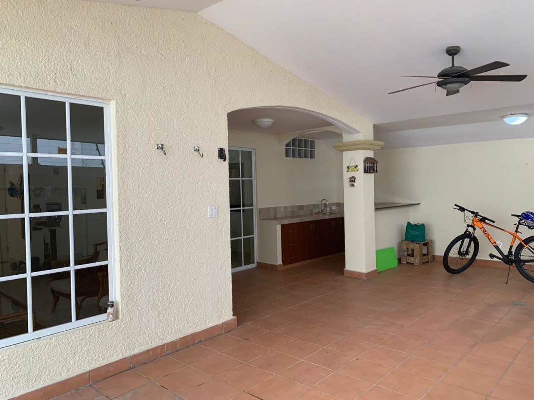 Traditional dining room with wooden furniture and pendant light in Dorado Springs house Panama City