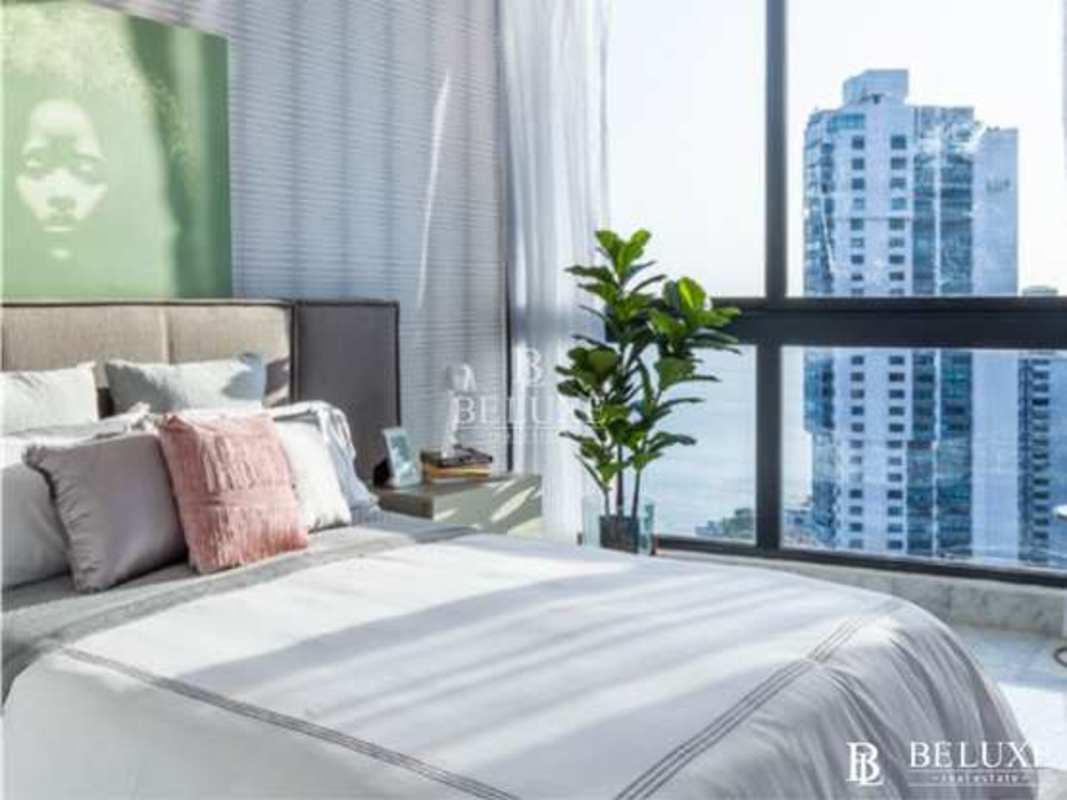 Elegant master bedroom with floor-to-ceiling windows and panoramic ocean vistas Punta Paitilla