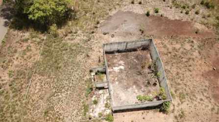 Aerial image showing boundary walls and open dirt ground in rural Panama