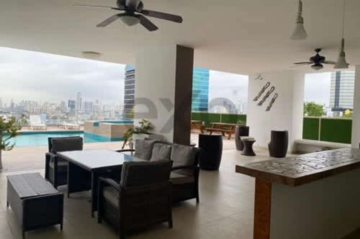 Bedroom with built-in dark wood wardrobe, ceiling fan, white walls PH Hill Tower Panama