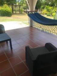 Living and dining room with exposed wood beams beach house in Coronado Panama