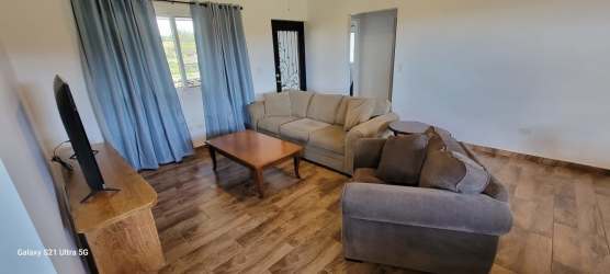 Modern kitchen with gas stove refrigerator and breakfast bar in Alto Boquete furnished rental Panama