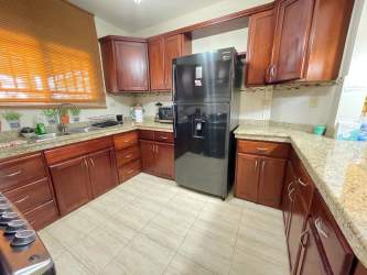 Furnished living and dining room with ceiling fan in Coquito Hills residence David Panama for rent