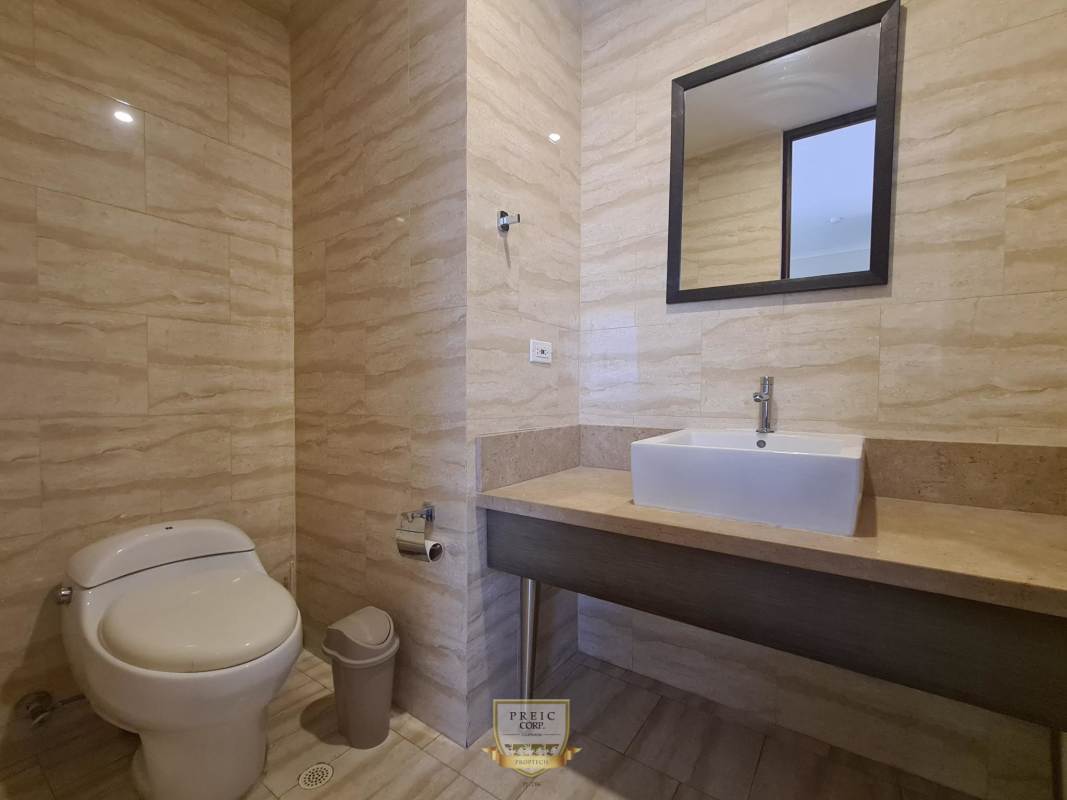 Living dining area with large windows overlooking Panama City skyline in PH Denovo