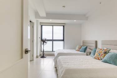 Modern kitchen with marble counters, island and custom cabinets in Punta Caelo luxury penthouse Panama