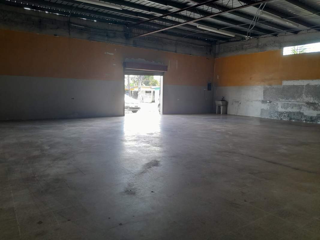 Interior warehouse space with open roll-up door and utility sink Pacora Panama City