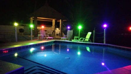 Covered outdoor terrace with dining table and garden at Costa Esmeralda beach house Panama