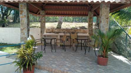 Bedroom with two white metal bunk beds, colorful bedding, AC and refrigerator Costa Esmeralda Panama