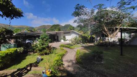 Side view residential estate with solar panel, palm trees, lush landscaping and mountain view Rio Hato Panama