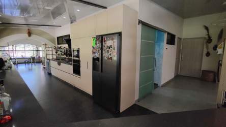 Contemporary kitchen featuring modern cabinetry, appliances and large windows in El Valle estate Panama