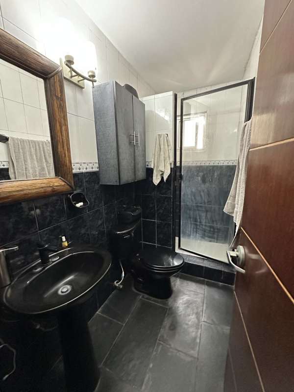 Bright living room in PH Del Rey penthouse with wood floors and terrace access El Cangrejo