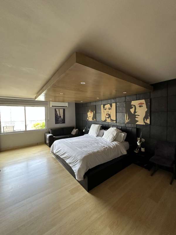 Contemporary dining room with wooden floors and large windows in PH Del Rey penthouse Panama