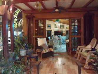 Indoor patio with wooden beams connected to dining area country home Los Lirios San Carlos