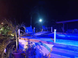 Night illuminated swimming pool with tropical plants Los Lirios San Carlos Panama