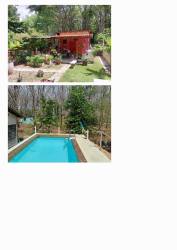 Garden with red shed swimming pool surrounded by greenery countryside house Los Lirios San Carlos