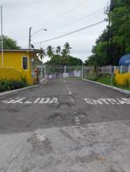 Secure residential entrance gate with yellow security booth Los Lirios San Carlos Panama