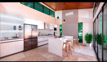 Bright kitchen in new beach home with marble counters, island seating, stainless appliances Costa Esmeralda Panama