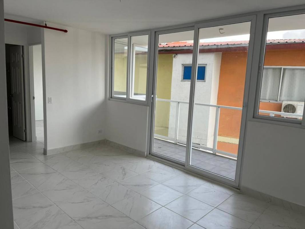 Bright living area with access to balcony white marble floors Mystic Gates Panama