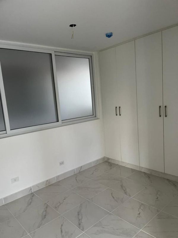 Modern kitchen and laundry space with granite countertop in Mystic Gates Panama City