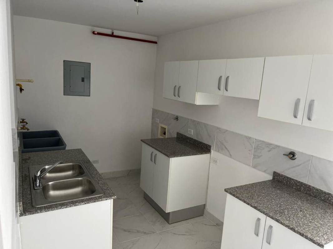 Laundry utility space with granite countertops and white cabinets Mystic Gates Panama