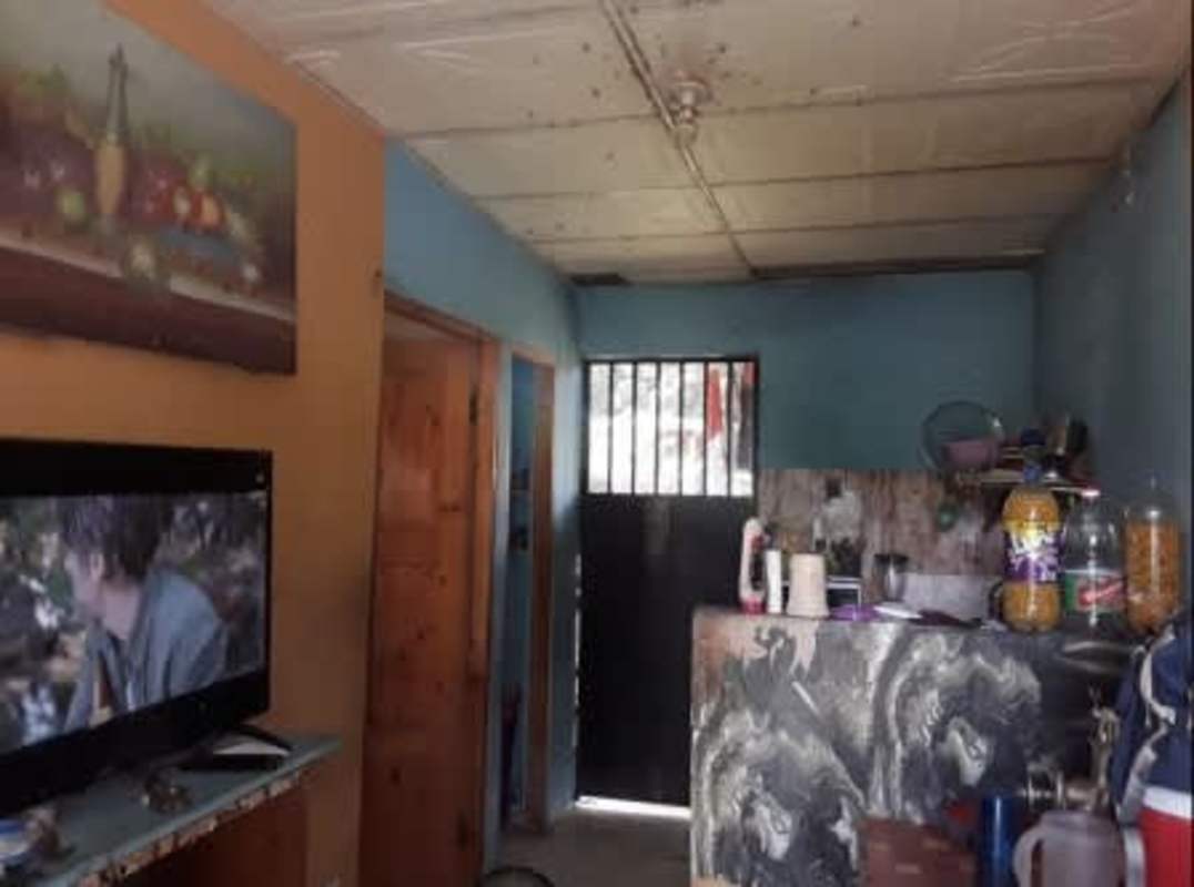Basic open space with kitchen counter and living area in San Miguelito Panama property