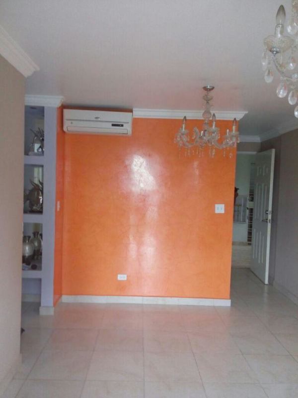 Contemporary living room with textured orange wall and air conditioning in apartment for rent PH Mystic Tower Chanis Panama