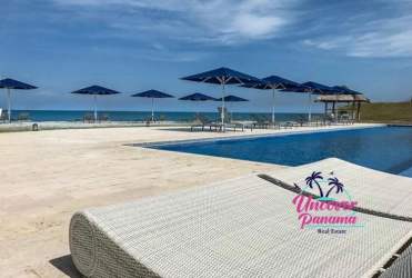 Infinity edge pool overlooking Pacific Ocean with lounge chairs at Casamar beach club Panama