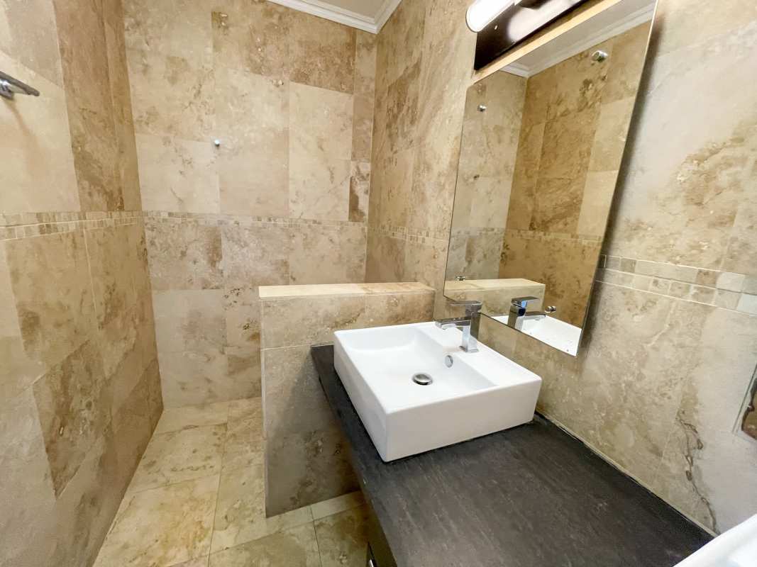 Closed kitchen with granite counters, gas stove, wooden cabinets at PH Pacific Coast San Francisco Panama