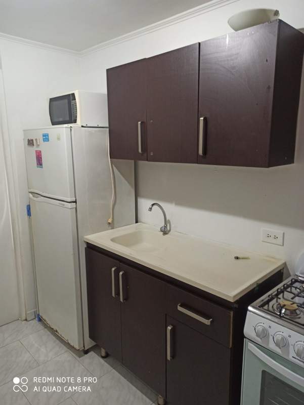 Small kitchen area cabinets fridge microwave stove apartment Panama City La Cresta