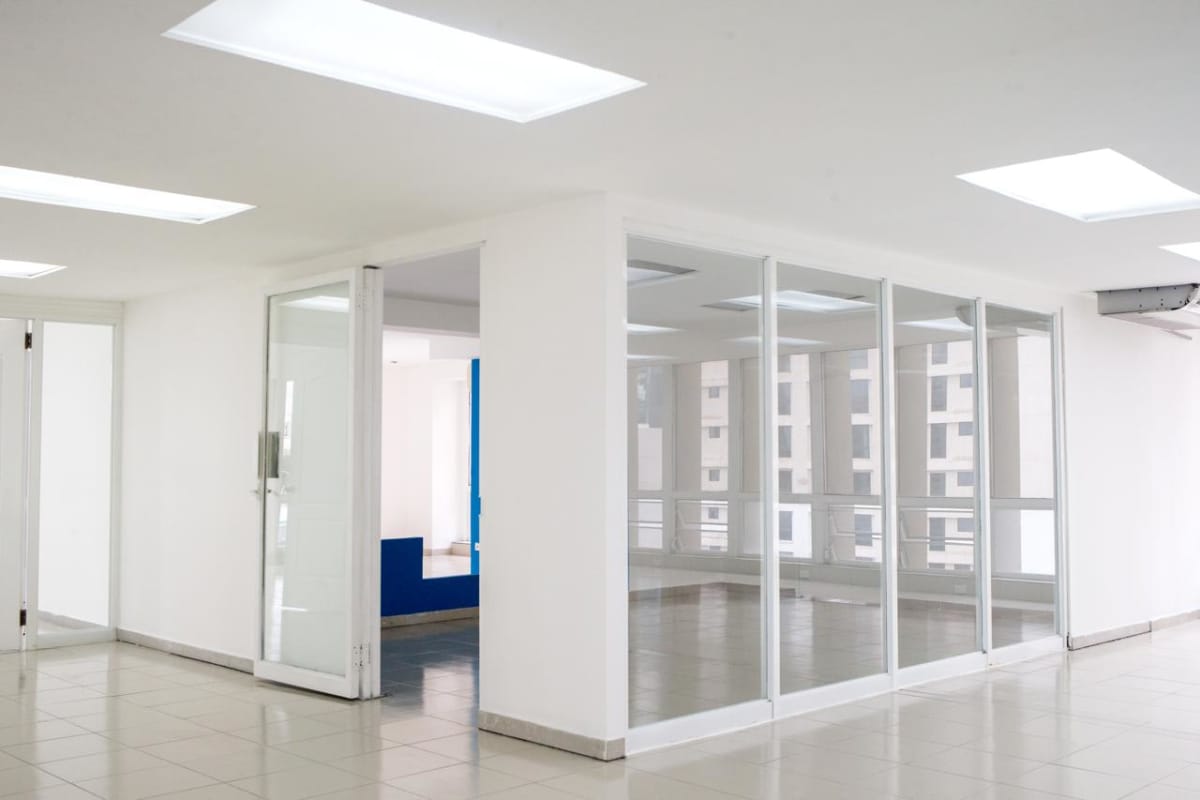 Vacant modern office with glass walls and tiled floors, panoramic windows at PH BICSA Financial Tower Panama