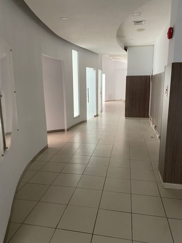 Bright interior hallway with glass walls and modern design in Bella Vista commercial tower Panama City