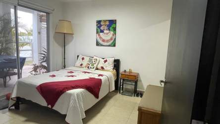 Bright bedroom with sliding glass door to terrace in Ibiza Beach Residences Río Hato