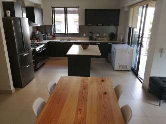 Spacious kitchen with island, window, stainless appliances PH River Valley Panama Pacifico