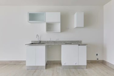 Bright minimalist kitchen with grey cabinets and granite countertop in Surfside Punta Chame beachfront condominium