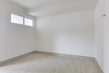 Contemporary white bathroom with glass shower enclosure in Surfside Playa Caracol apartment Punta Chame Panama